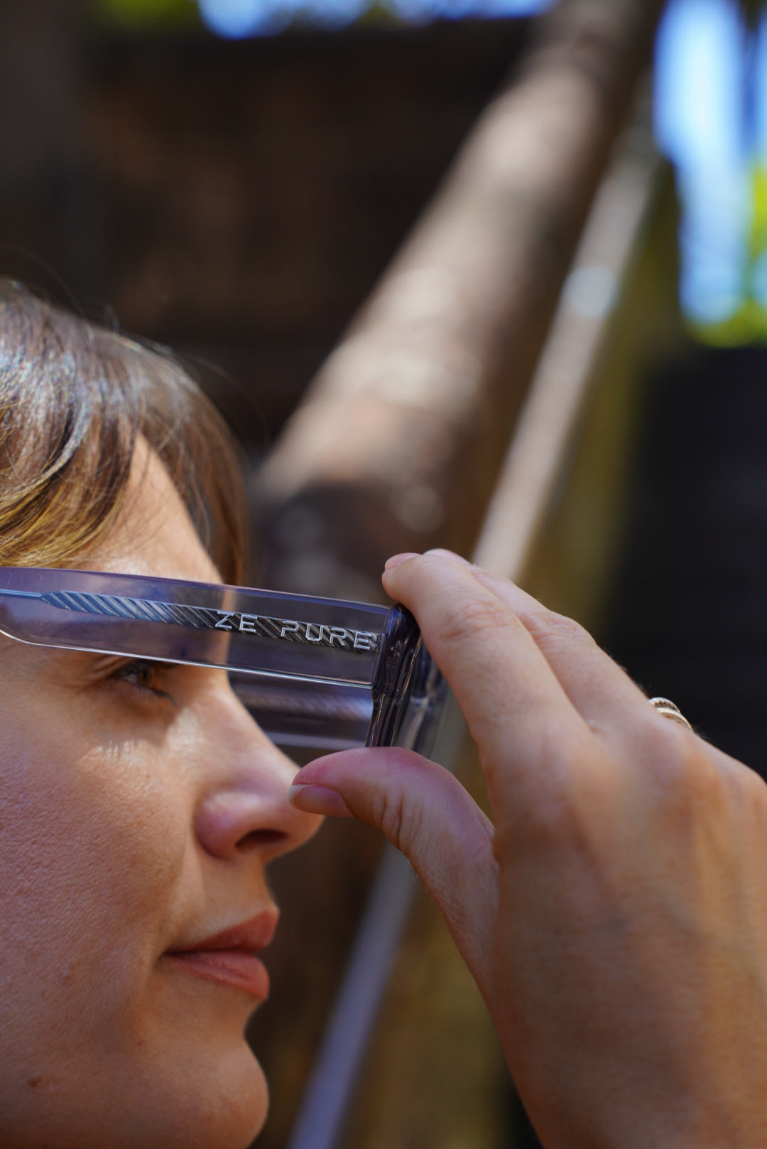 A woman wearing Zepure's Sunny Confidence clear glasses frames.