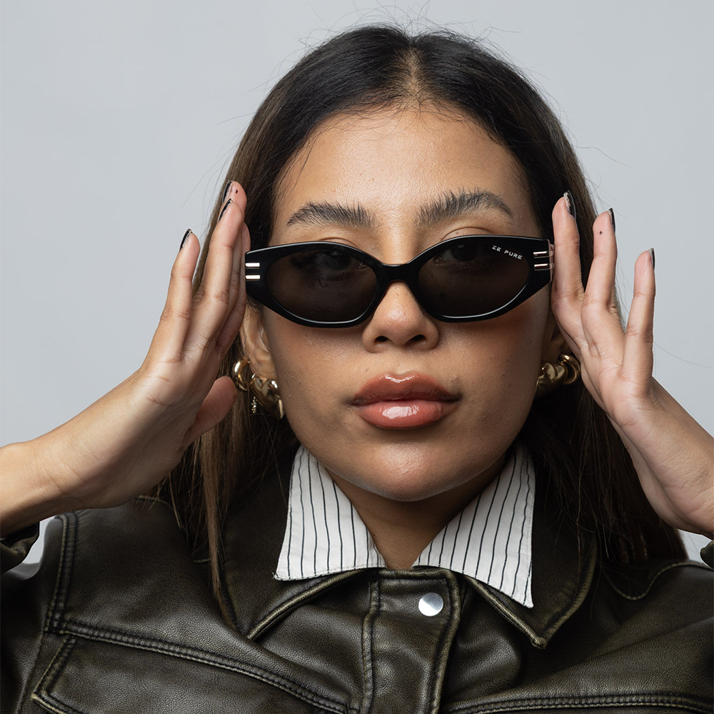 Woman wearing sunglasses with a neutral background