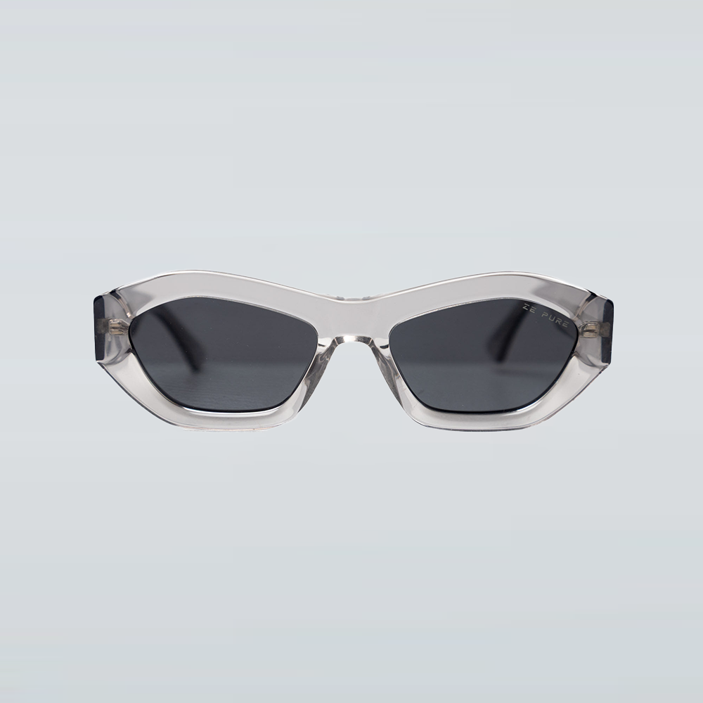 Sunglasses with a clear frame and dark lenses on a light gray background